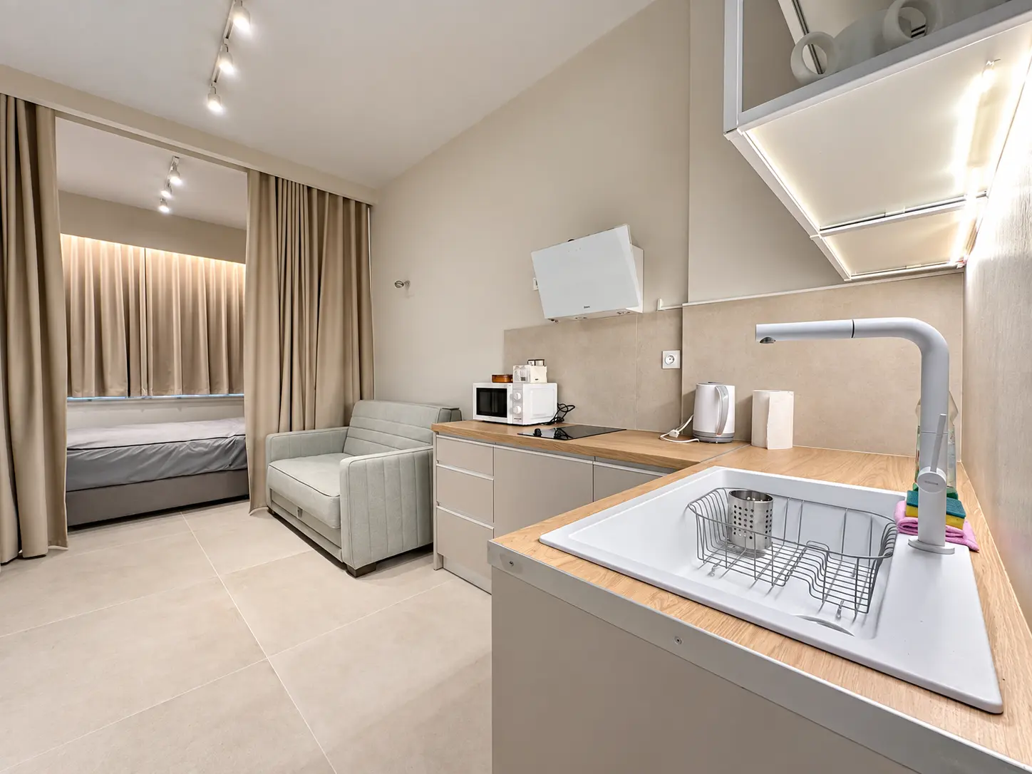 Renovated studio apartment interior with kitchen and sleeping area, Akadimias 85 Athens