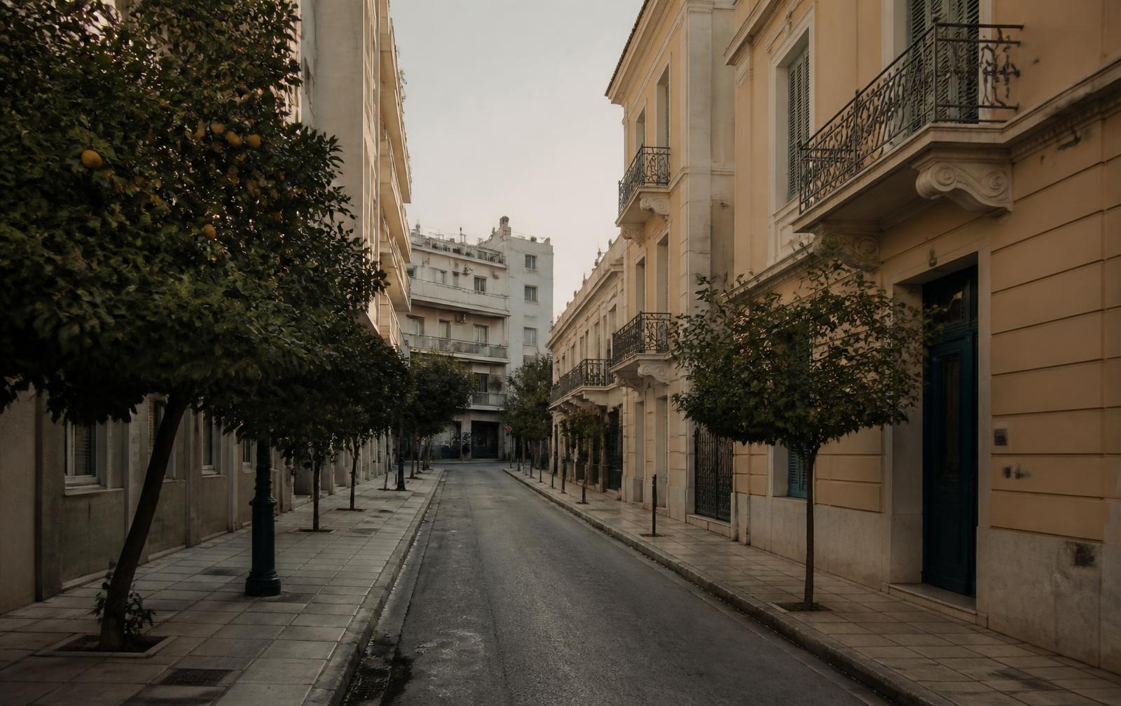 A quiet residential street in central Athens with neoclassical and modern buildings